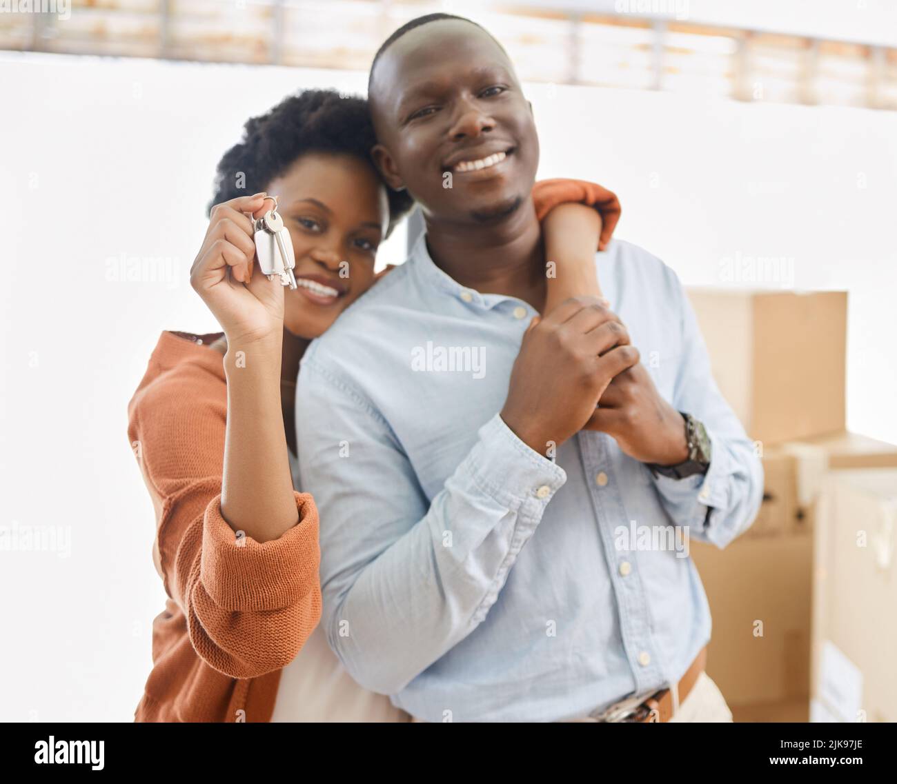 The keys to a new beginning. a young couple showing the keys to their