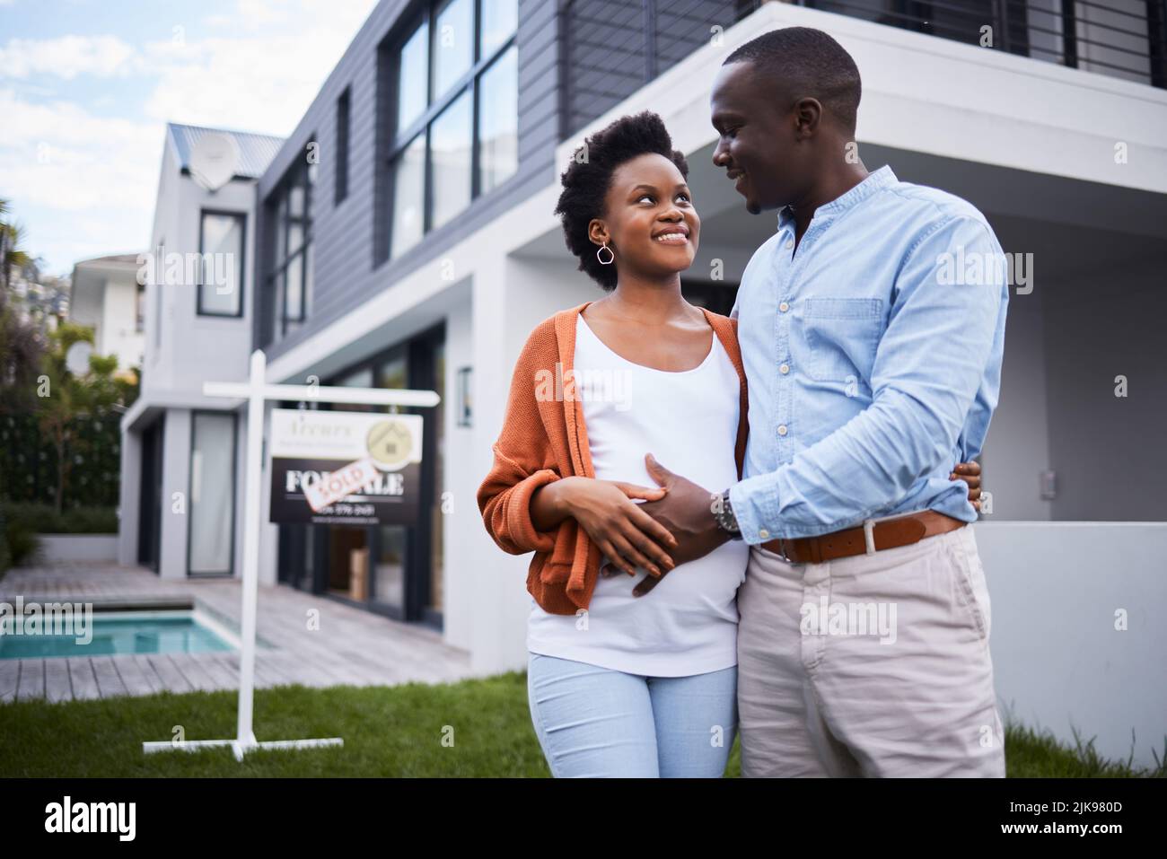 Upsizing their residence and family. Portrait of a young couple ...