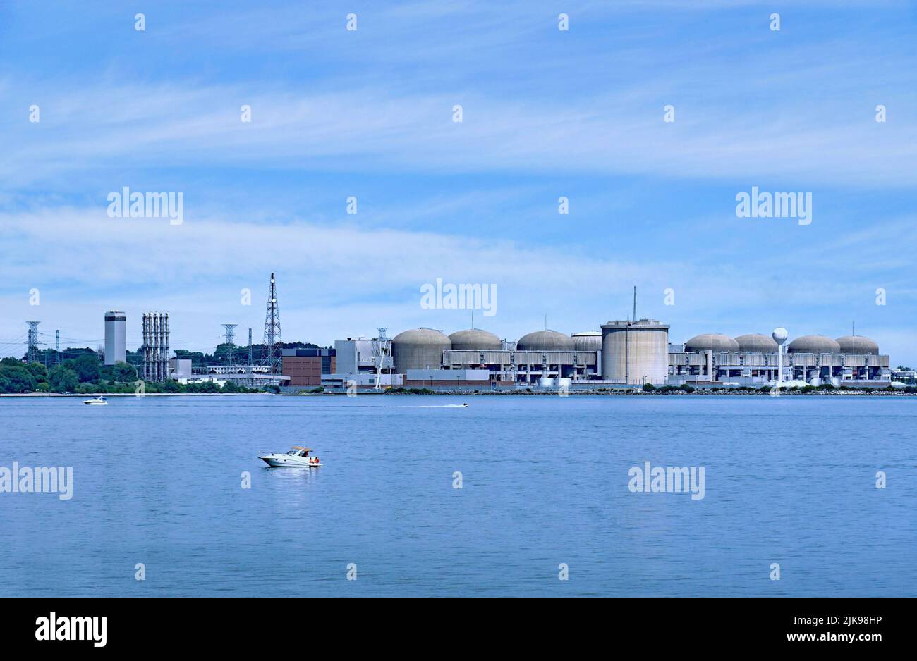 Boaters on Lake Ontario enjoy a summer day in front of the Pickering Nuclear Power Generating station in the Toronto area Stock Photo