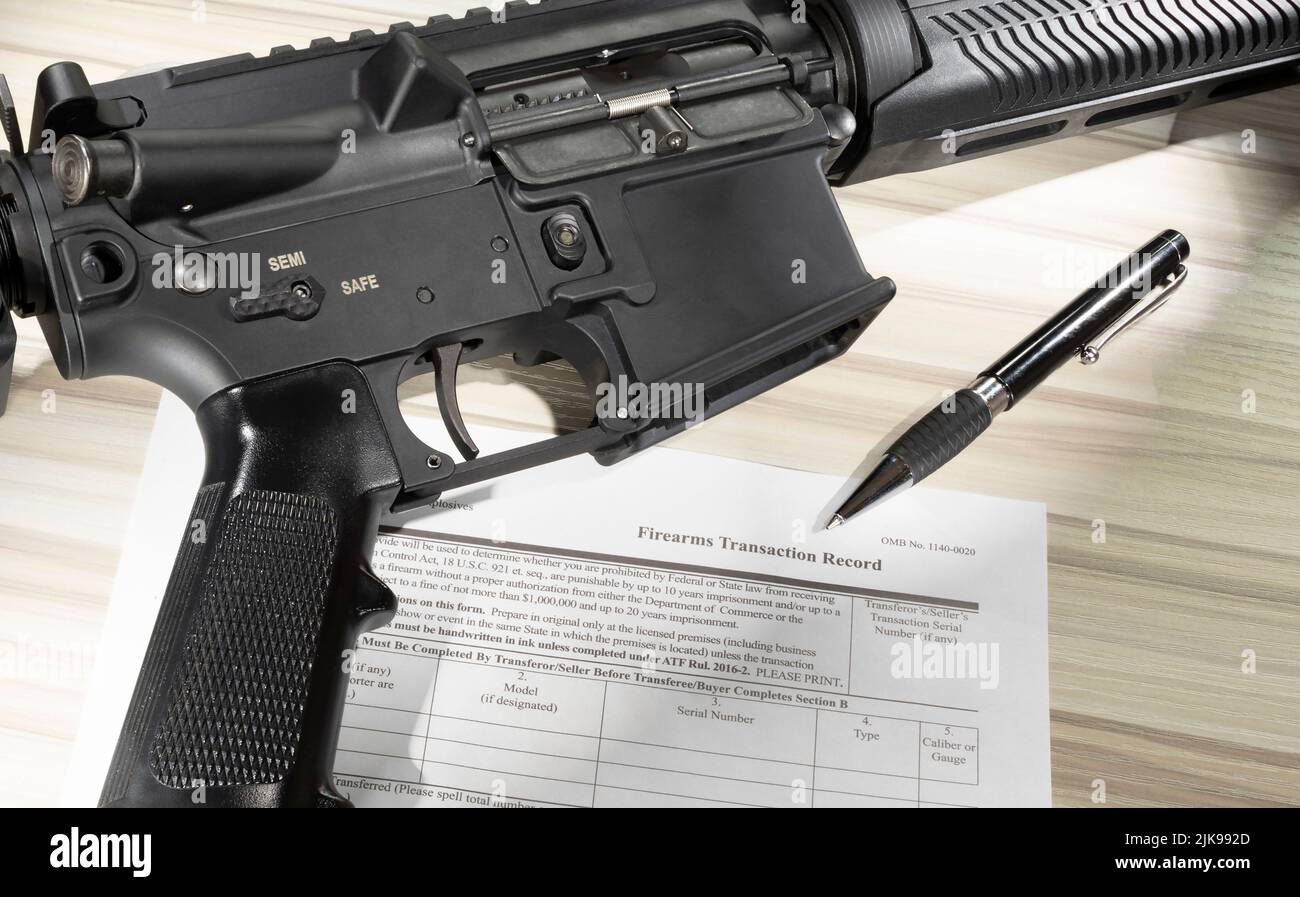 Weapon and public domain 4473 form for its purchase with a pen Stock ...