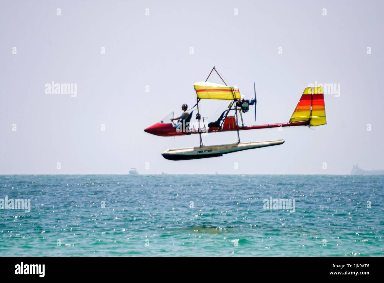 Miami Beach Florida,Atlantic Ocean seashore,ultralight airplane flying low over ocean pilot,scene in a photo Stock Photo