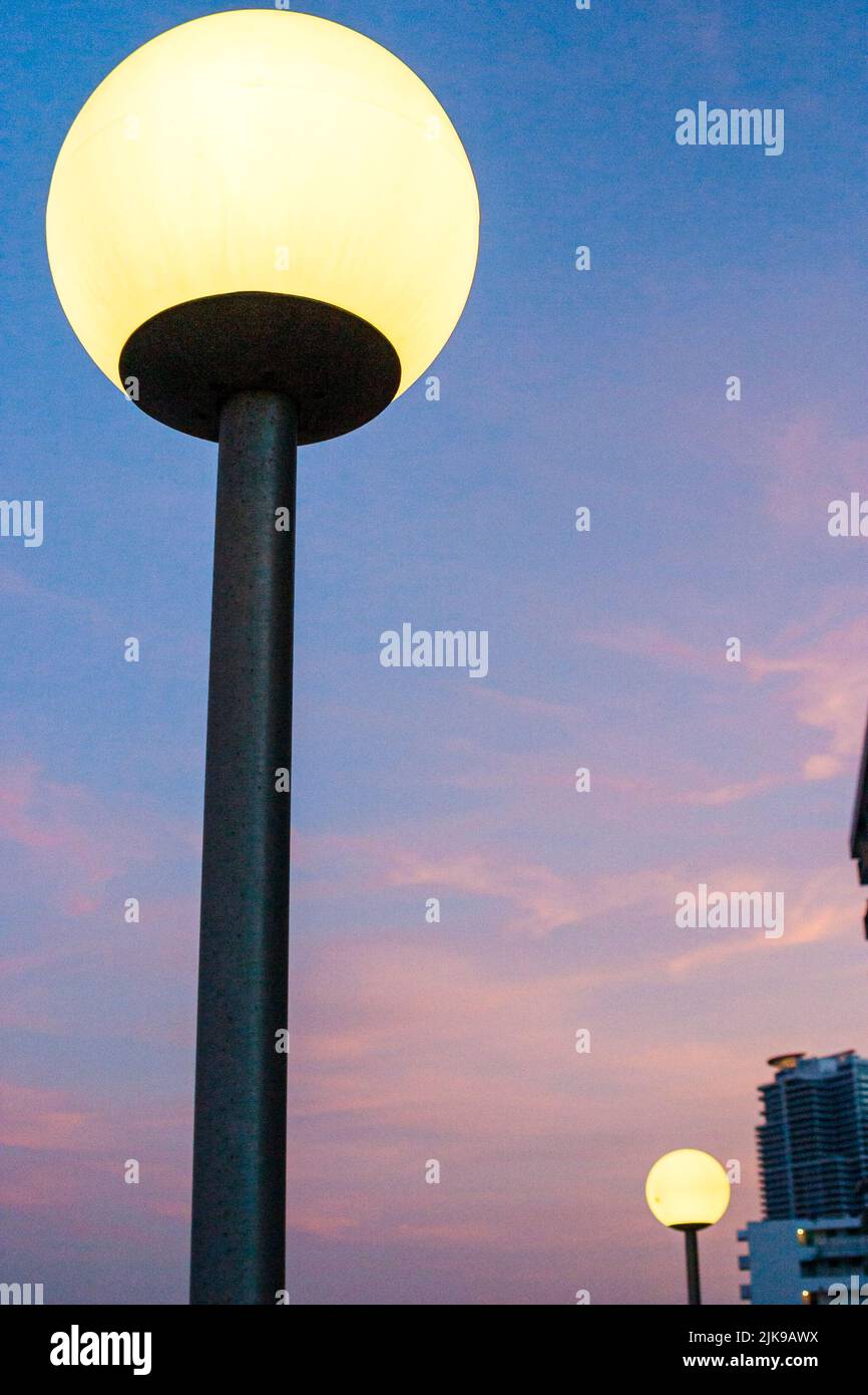 Miami Beach Florida,lighted light globe on pole at dusk evening night scene in a photo,USA US United States,America North American Americans Stock Photo