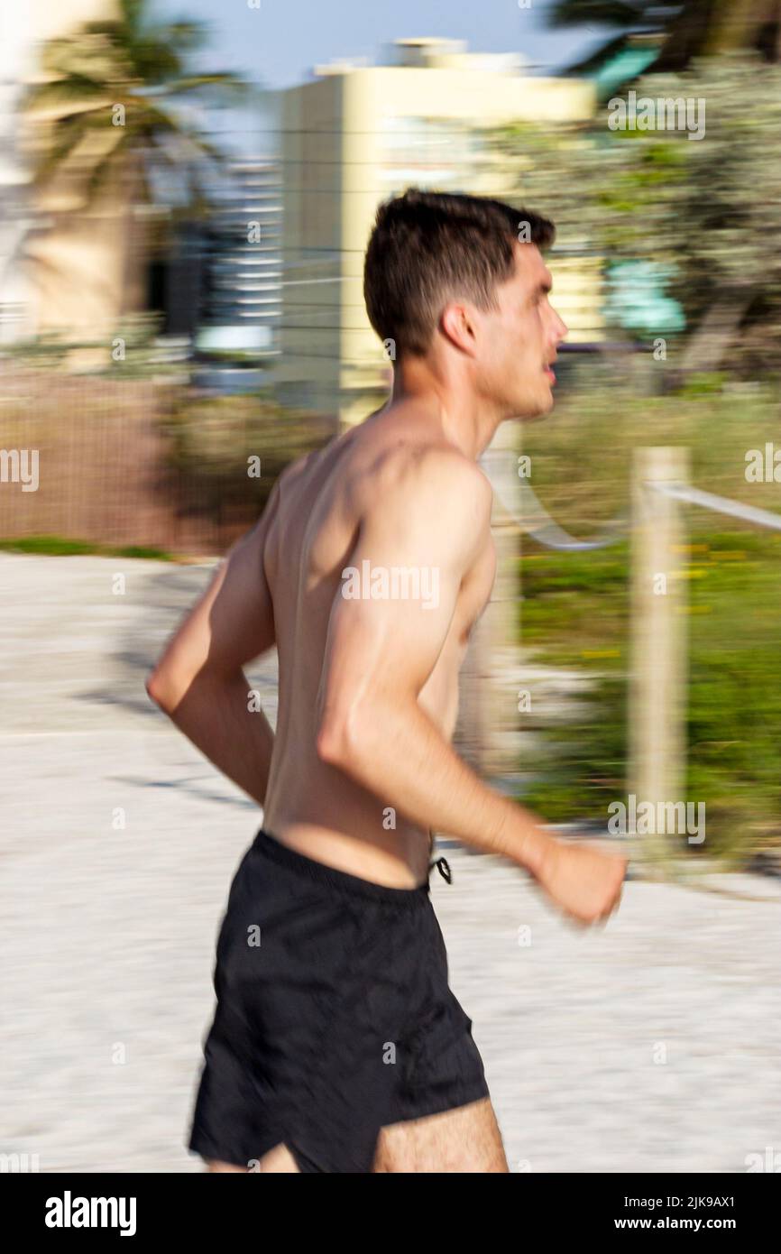 Miami Beach Florida,adult adults man men male,jogger,joggers,jogging,runner,runners,running fit fitness people person scene in a photo Stock Photo