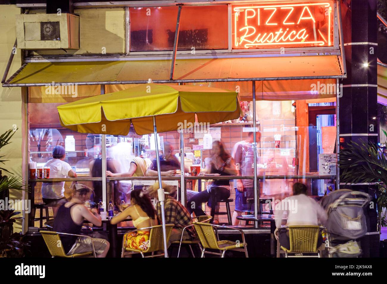 Miami Beach Florida,Collins Avenue,Pizza Rustica,Italian restaurant restaurants pizzeria,dining parlor al fresco,night nightlife evening group people Stock Photo