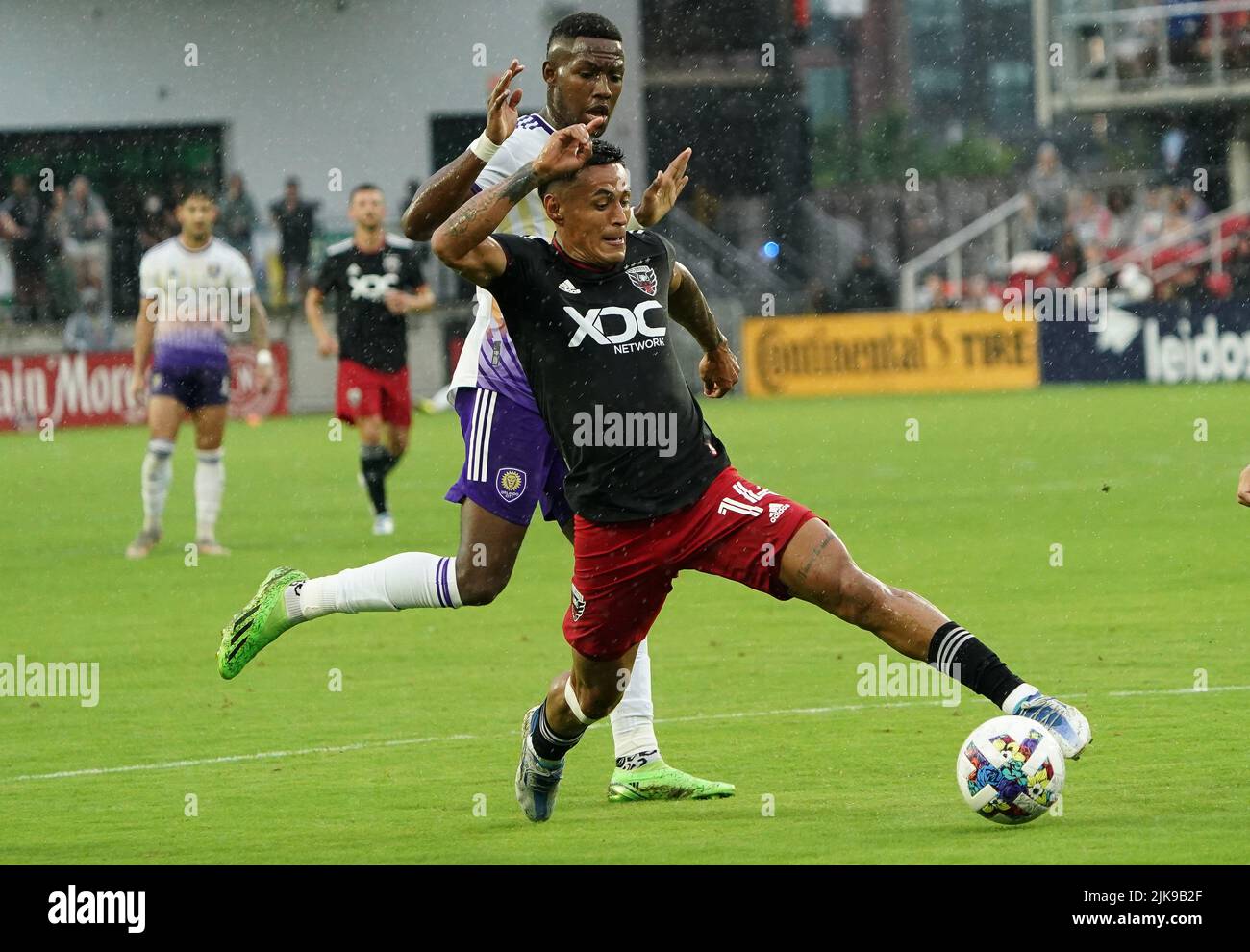 WASHINGTON, DC, USA - 31 JULY 2022: D.C. United midfielder Andy Najar (14) dribbles past Orlando City forward Jack Lynn (27) during a MLS match between D.C United and the Orlando City SC, on July 31, 2022, at Audi Field, in Washington, DC. (Photo by Tony Quinn-Alamy Live News) Stock Photo