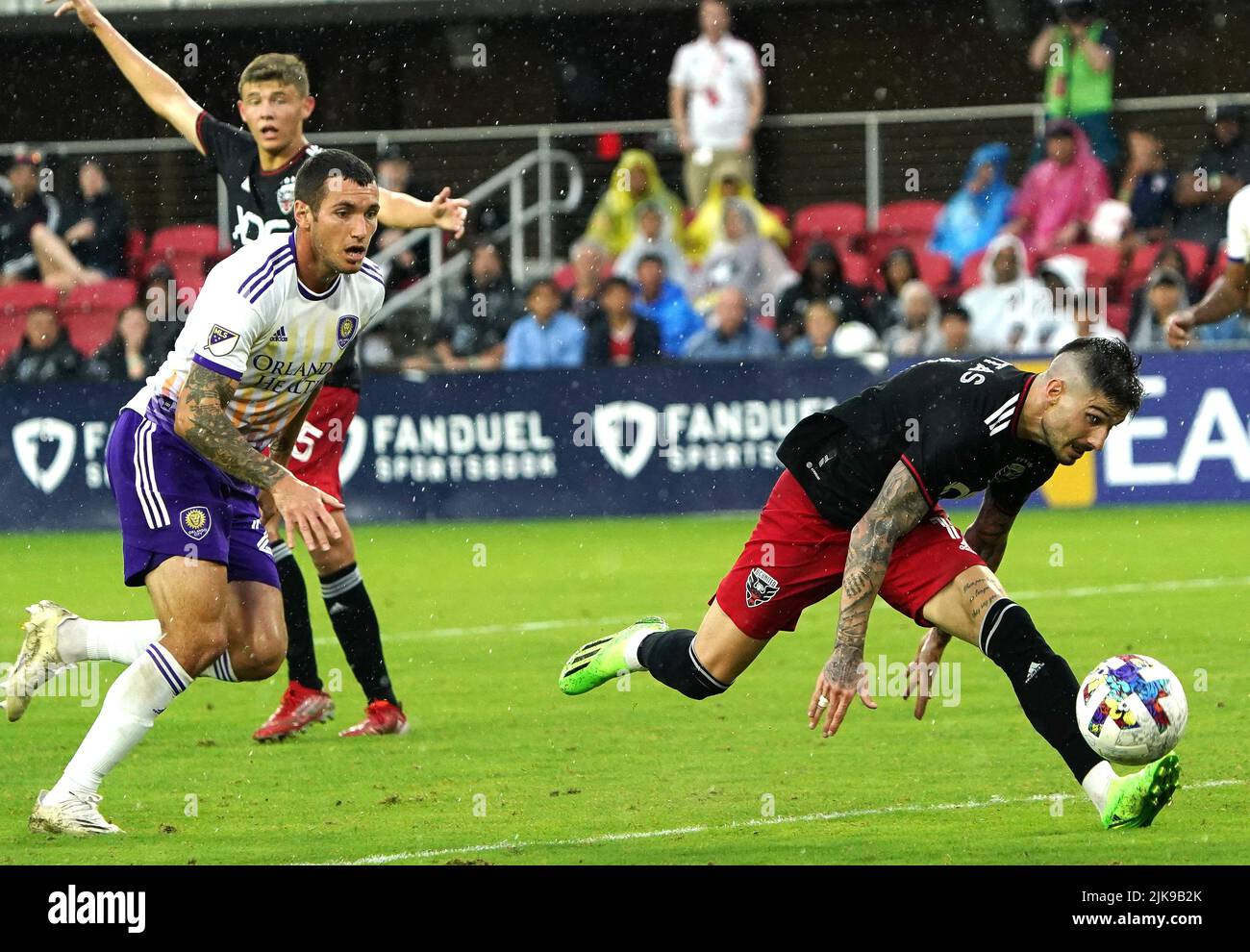 WASHINGTON, DC, USA - 31 JULY 2022: D.C. United forward Taxiarchis Fountas (11) lungs for the bal in front of Orlando City defender Antônio Carlos (25) during a MLS match between D.C United and the Orlando City SC, on July 31, 2022, at Audi Field, in Washington, DC. (Photo by Tony Quinn-Alamy Live News) Stock Photo