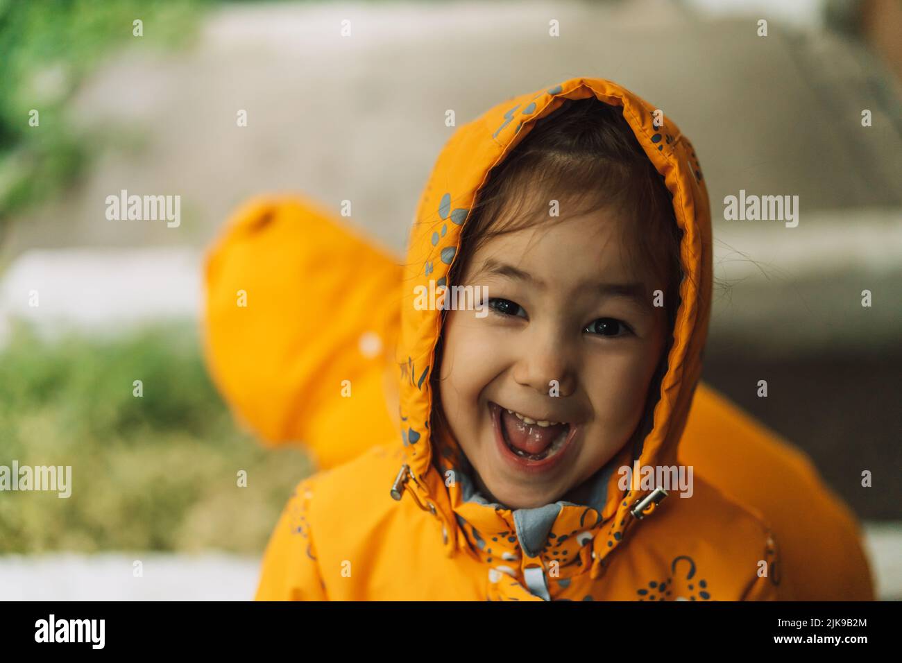Children in yellow rain suits standing in the rain stock photo alamy