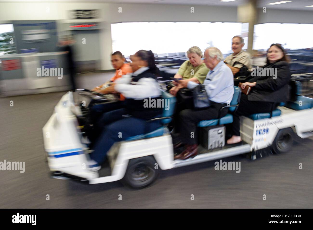 Houston Texas,George Bush Intercontinental Airport,terminal gate area,electric cart carrying physically challenged airline passengers to flights Stock Photo