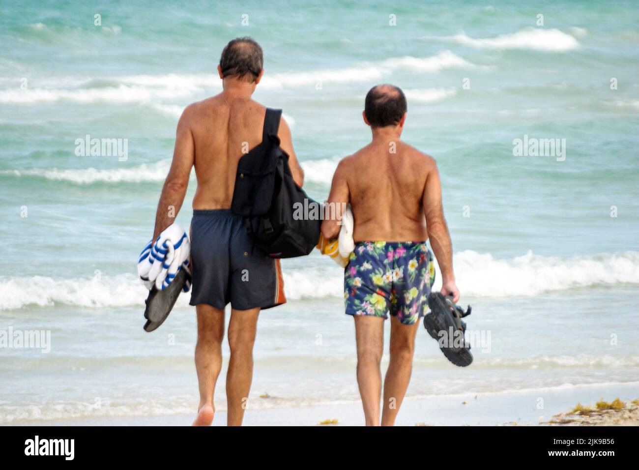 Two 2 men man male friends walking talking hires stock