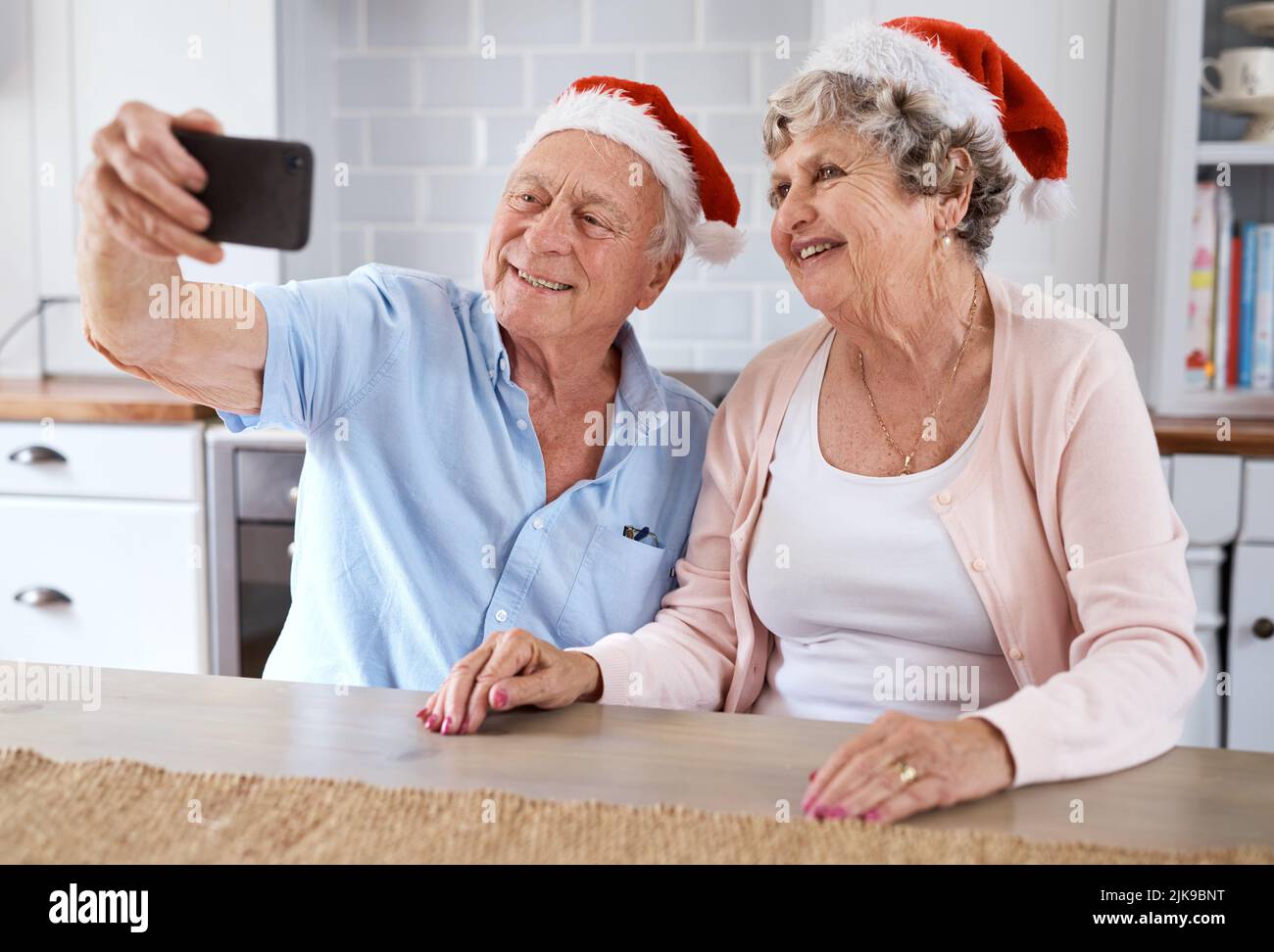 Remember me... an elderly couple taking a festive selfie at home. Stock Photo