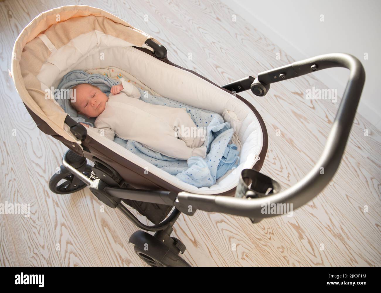 A little sleeping newborn baby lying in the pram Stock Photo Alamy