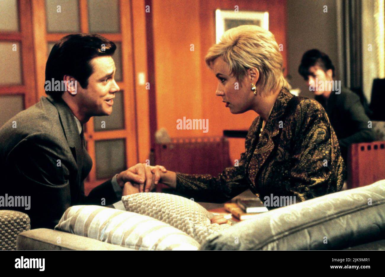 Jim Carrey & Jennifer Tilly Film: Liar Liar (1997) Characters: Fletcher Reede & Samantha Cole  Director: Tom Shadyac 21 March 1997   **WARNING** This Photograph is for editorial use only and is the copyright of UNIVERSAL and/or the Photographer assigned by the Film or Production Company and can only be reproduced by publications in conjunction with the promotion of the above Film. A Mandatory Credit To UNIVERSAL is required. The Photographer should also be credited when known. No commercial use can be granted without written authority from the Film Company. Stock Photo