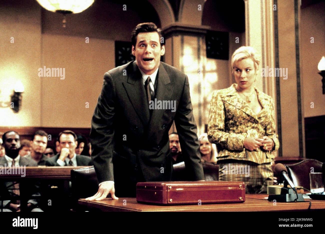 Jim Carrey & Jennifer Tilly Film: Liar Liar (1997) Characters: Fletcher Reede & Samantha Cole  Director: Tom Shadyac 21 March 1997   **WARNING** This Photograph is for editorial use only and is the copyright of UNIVERSAL and/or the Photographer assigned by the Film or Production Company and can only be reproduced by publications in conjunction with the promotion of the above Film. A Mandatory Credit To UNIVERSAL is required. The Photographer should also be credited when known. No commercial use can be granted without written authority from the Film Company. Stock Photo