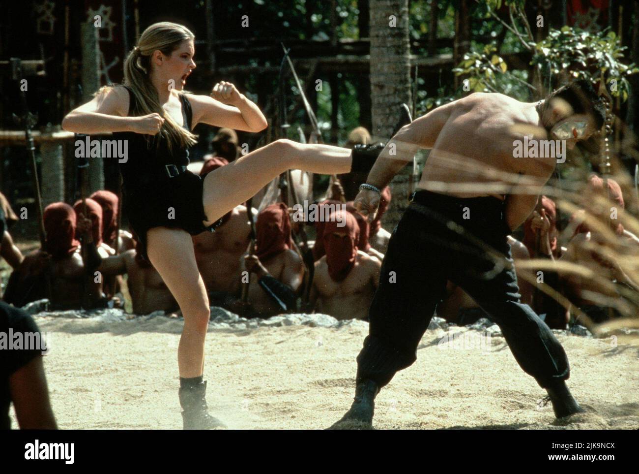 Bridgette Wilson & Trevor Goddard Film: Mortal Kombat (1998) Characters: Sonya Blade & Kano  Director: Paul W.S. Anderson 13 July 1995   **WARNING** This Photograph is for editorial use only and is the copyright of NEW LINE and/or the Photographer assigned by the Film or Production Company and can only be reproduced by publications in conjunction with the promotion of the above Film. A Mandatory Credit To NEW LINE is required. The Photographer should also be credited when known. No commercial use can be granted without written authority from the Film Company. Stock Photo