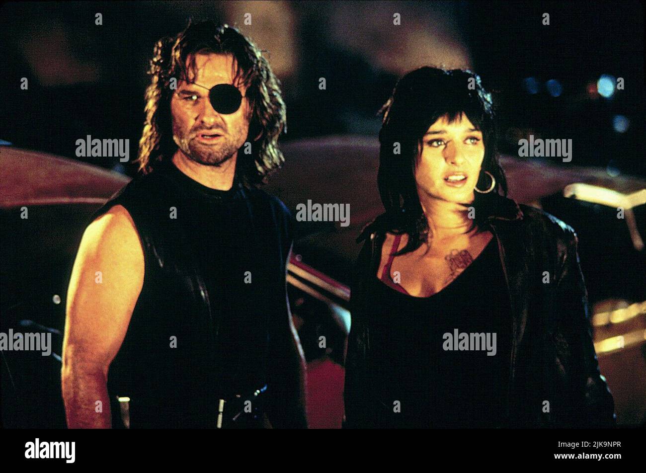 Kurt Russell & Valeria Golino Film: Escape From L.A. (USA 1996) Characters: Snake Plissken & Taslima  Director: John Carpenter 09 August 1996   **WARNING** This Photograph is for editorial use only and is the copyright of PARAMOUNT PICTURES and/or the Photographer assigned by the Film or Production Company and can only be reproduced by publications in conjunction with the promotion of the above Film. A Mandatory Credit To PARAMOUNT PICTURES is required. The Photographer should also be credited when known. No commercial use can be granted without written authority from the Film Company. Stock Photo