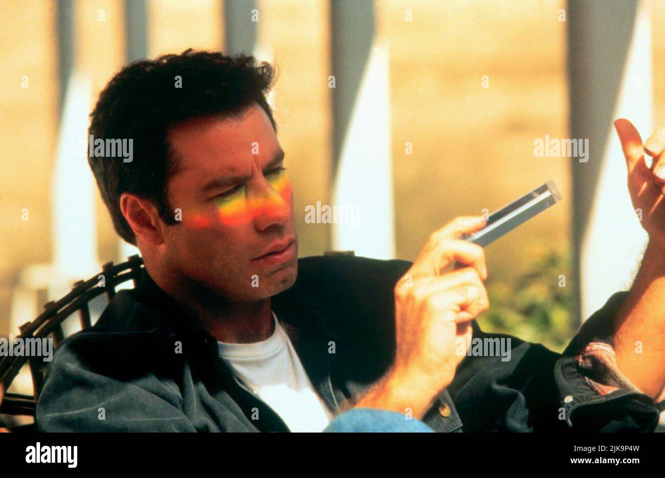 John Travolta Film: Phenomenon (1996) Characters: George Malley  Director: Jon Turteltaub 03 July 1996   **WARNING** This Photograph is for editorial use only and is the copyright of TOUCHSTONE and/or the Photographer assigned by the Film or Production Company and can only be reproduced by publications in conjunction with the promotion of the above Film. A Mandatory Credit To TOUCHSTONE is required. The Photographer should also be credited when known. No commercial use can be granted without written authority from the Film Company. Stock Photo