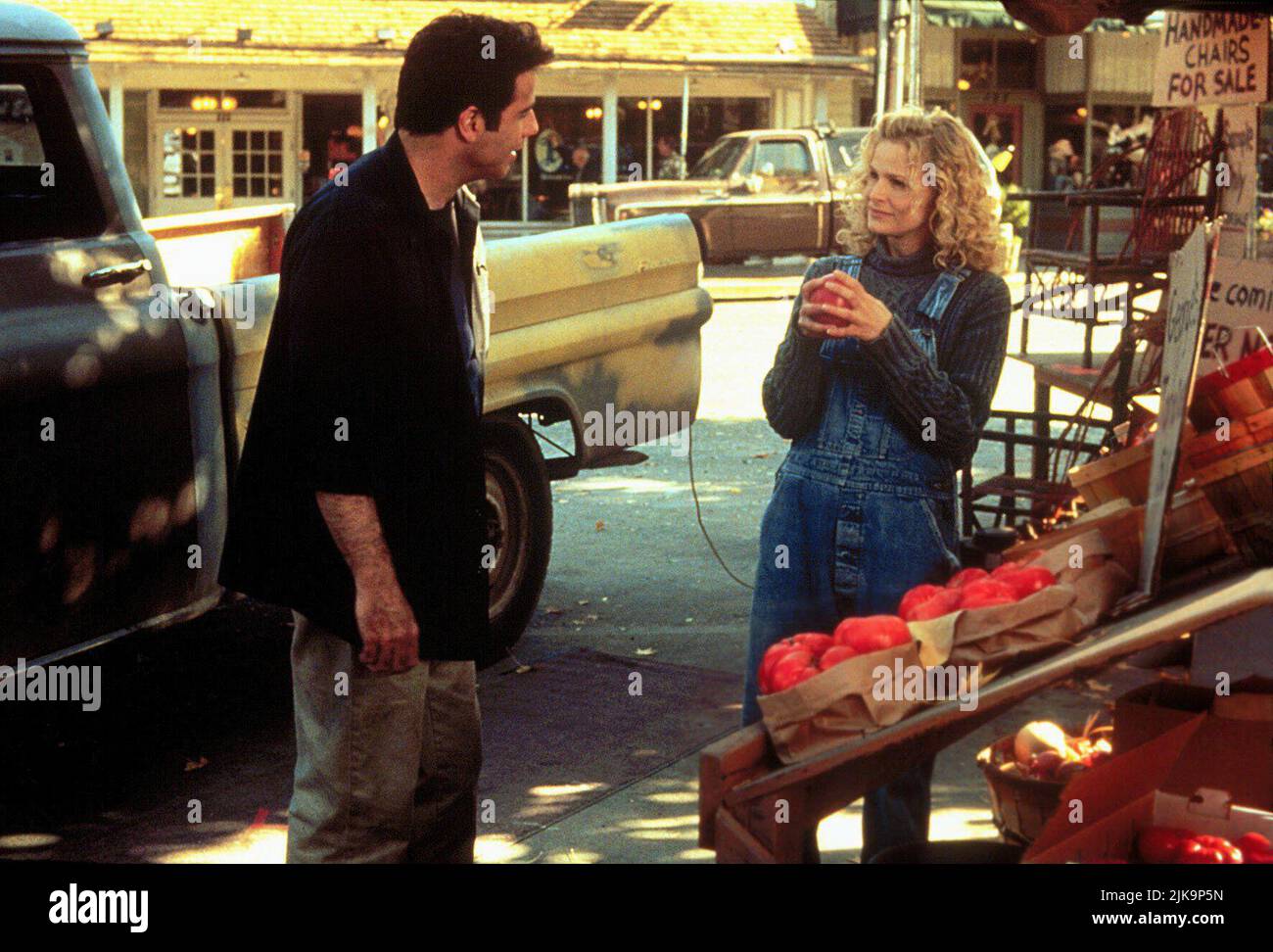 John Travolta & Kyra Sedgwick Film: Phenomenon (1996) Characters: George Malley & Lace Pennamin  Director: Jon Turteltaub 03 July 1996   **WARNING** This Photograph is for editorial use only and is the copyright of TOUCHSTONE and/or the Photographer assigned by the Film or Production Company and can only be reproduced by publications in conjunction with the promotion of the above Film. A Mandatory Credit To TOUCHSTONE is required. The Photographer should also be credited when known. No commercial use can be granted without written authority from the Film Company. Stock Photo