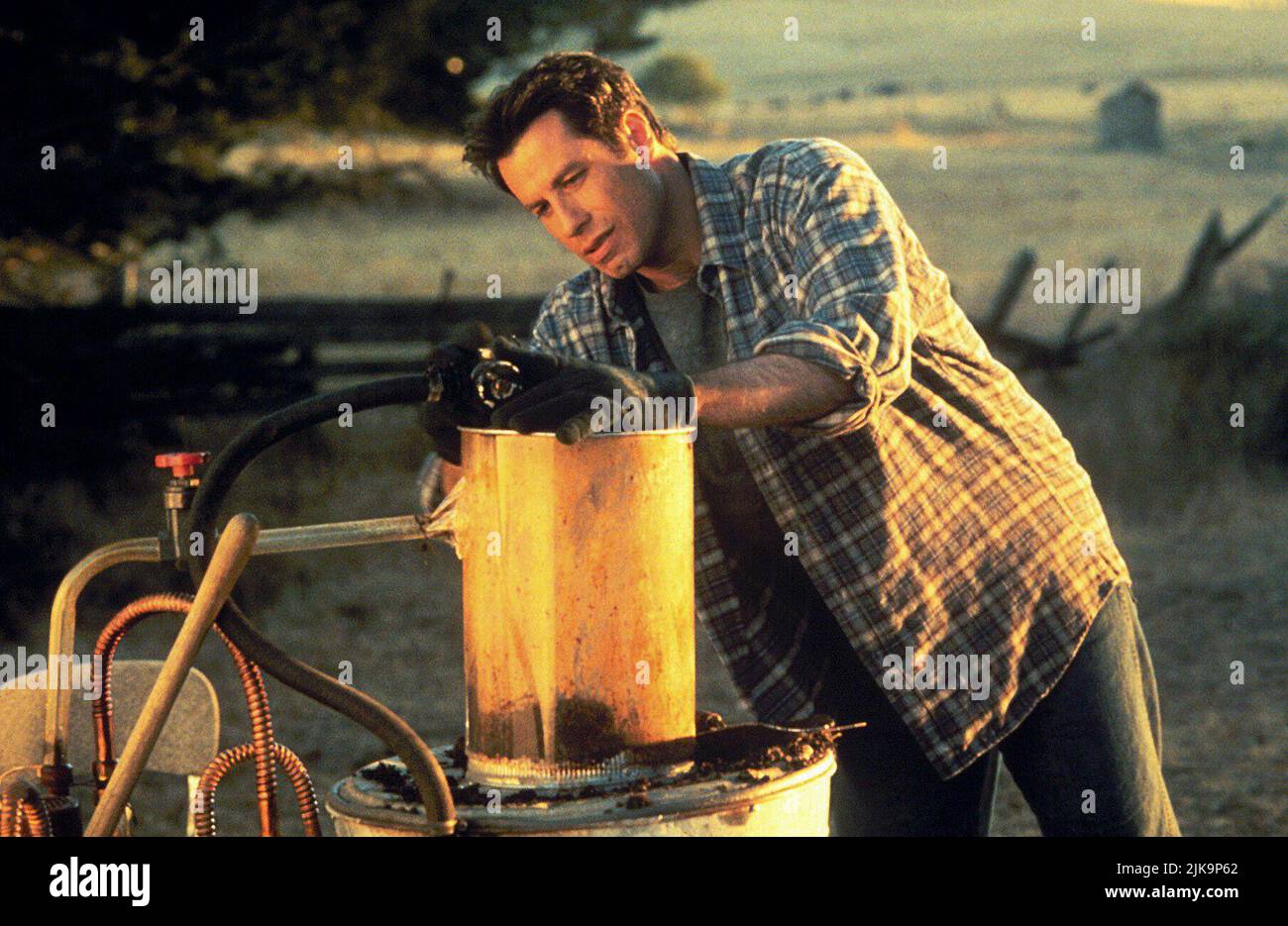 John Travolta Film: Phenomenon (1996) Characters: George Malley  Director: Jon Turteltaub 03 July 1996   **WARNING** This Photograph is for editorial use only and is the copyright of TOUCHSTONE and/or the Photographer assigned by the Film or Production Company and can only be reproduced by publications in conjunction with the promotion of the above Film. A Mandatory Credit To TOUCHSTONE is required. The Photographer should also be credited when known. No commercial use can be granted without written authority from the Film Company. Stock Photo