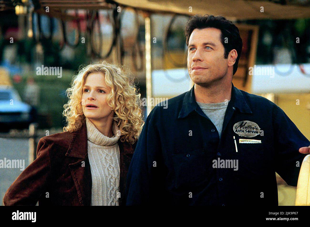 Kyra Sedgwick & John Travolta Film: Phenomenon (1996) Characters: Lace Pennamin & George Malley  Director: Jon Turteltaub 03 July 1996   **WARNING** This Photograph is for editorial use only and is the copyright of TOUCHSTONE and/or the Photographer assigned by the Film or Production Company and can only be reproduced by publications in conjunction with the promotion of the above Film. A Mandatory Credit To TOUCHSTONE is required. The Photographer should also be credited when known. No commercial use can be granted without written authority from the Film Company. Stock Photo