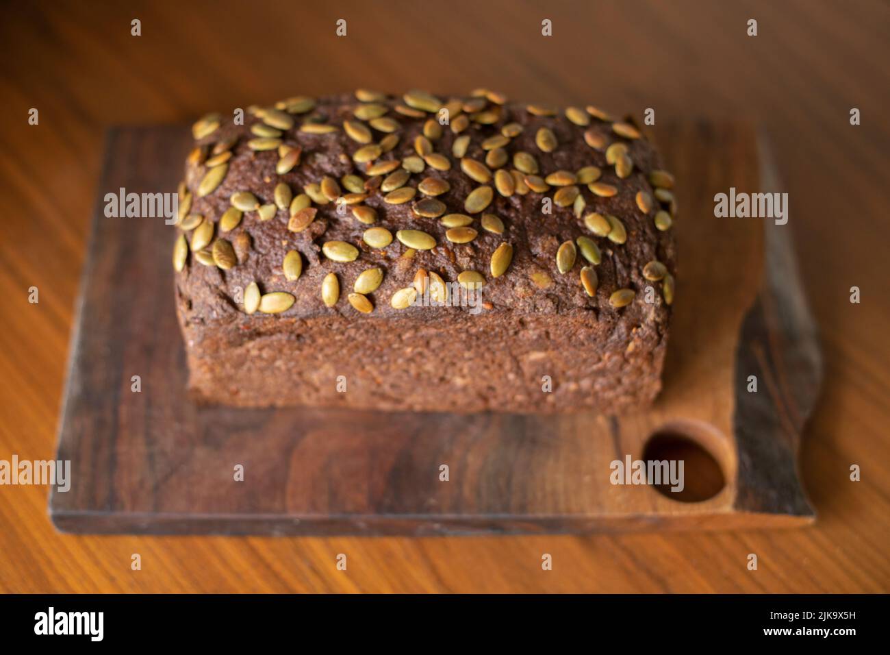 Pumpernickel or mock-rye style gluten-free seeded sourdough bread made from teff and buckwheat flour. Stock Photo