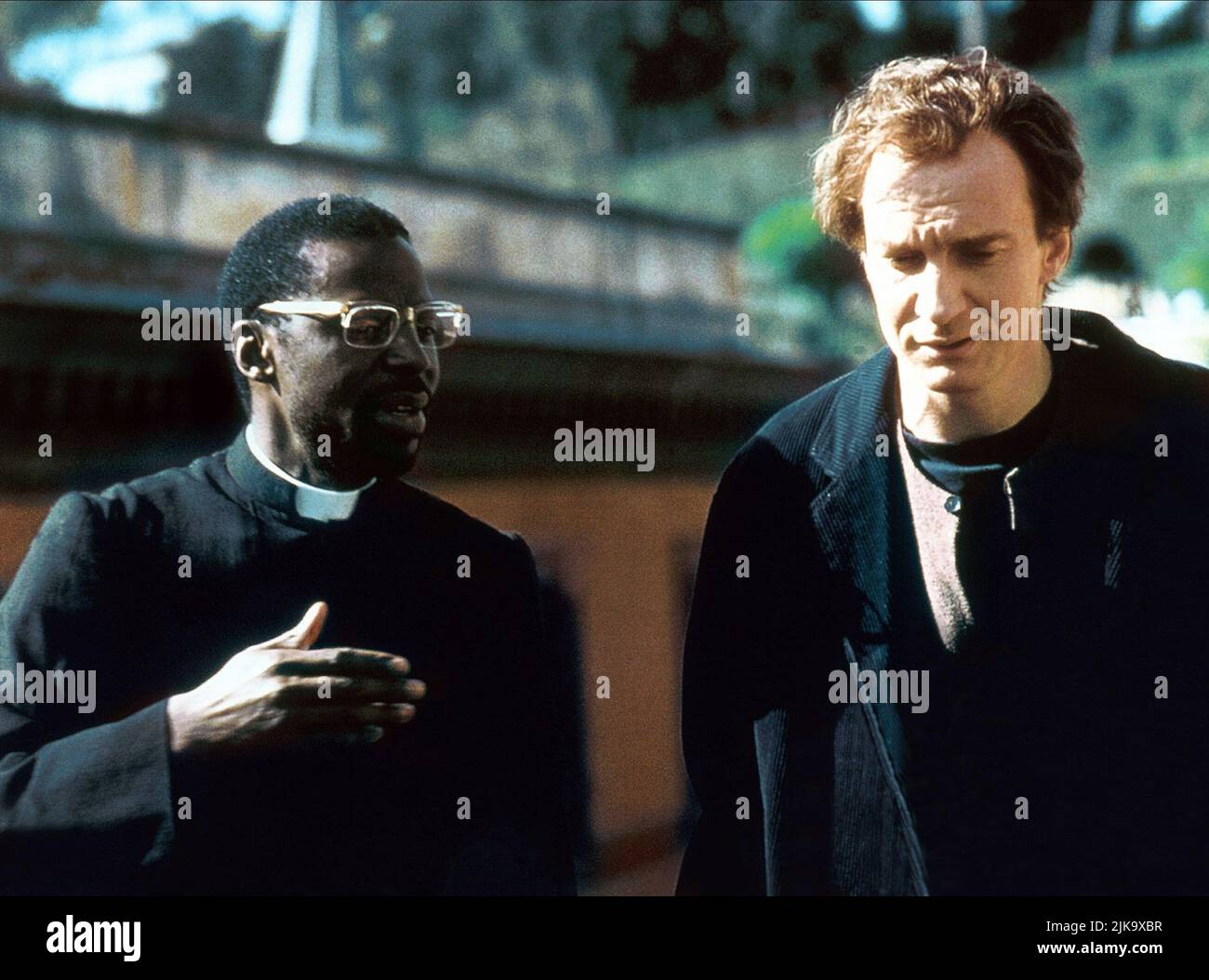 David Thewlis & Cyril Nri Film: Besieged (L'assedio) Characters: Jason Kinsky, Priest  It/Uk 1998, Director: Bernardo Bertolucci 14 September 1998   **WARNING** This Photograph is for editorial use only and is the copyright of NAVERT FILMBBC and/or the Photographer assigned by the Film or Production Company and can only be reproduced by publications in conjunction with the promotion of the above Film. A Mandatory Credit To NAVERT FILMBBC is required. The Photographer should also be credited when known. No commercial use can be granted without written authority from the Film Company. Stock Photo