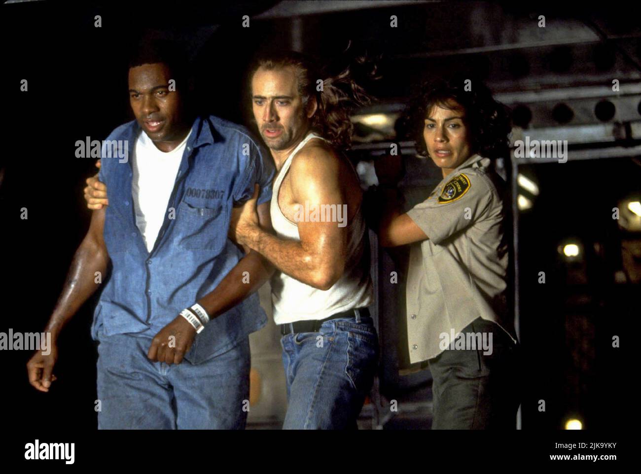 Mykelti Williamson, Nicolas Cage & Rachel Ticotin Film: Con Air (USA 1997) Characters: Mike 'Baby-O' O'Dell, Cameron Poe, Guard Sally Bishop  Director: Simon West 02 June 1997   **WARNING** This Photograph is for editorial use only and is the copyright of TOUCHSTONE PICTURES and/or the Photographer assigned by the Film or Production Company and can only be reproduced by publications in conjunction with the promotion of the above Film. A Mandatory Credit To TOUCHSTONE PICTURES is required. The Photographer should also be credited when known. No commercial use can be granted without written auth Stock Photo