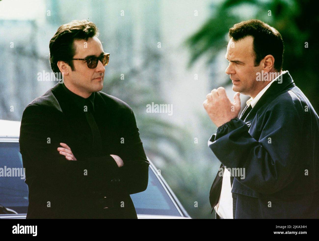 John Cusack & Dan Aykroyd Film: Grosse Pointe Blank (1997) Characters: Martin Q. Blank & Grocer  Director: George Armitage 11 April 1997   **WARNING** This Photograph is for editorial use only and is the copyright of BUENA VISTA and/or the Photographer assigned by the Film or Production Company and can only be reproduced by publications in conjunction with the promotion of the above Film. A Mandatory Credit To BUENA VISTA is required. The Photographer should also be credited when known. No commercial use can be granted without written authority from the Film Company. Stock Photo