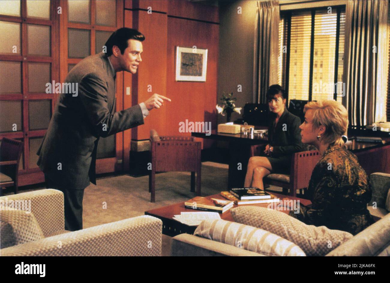 Jim Carrey, Amanda Donohoe & Jennifer Tilly Film: Liar Liar (1997) Characters: FLETCHER REEDE, MIRANDA, SAMANTHA COLE  Director: Tom Shadyac 21 March 1997   **WARNING** This Photograph is for editorial use only and is the copyright of UNIVERSAL and/or the Photographer assigned by the Film or Production Company and can only be reproduced by publications in conjunction with the promotion of the above Film. A Mandatory Credit To UNIVERSAL is required. The Photographer should also be credited when known. No commercial use can be granted without written authority from the Film Company. Stock Photo