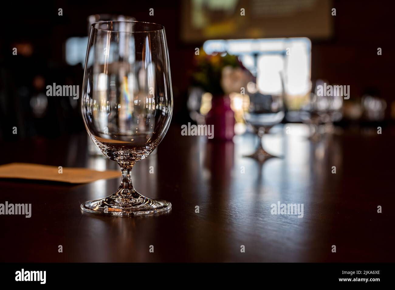 Formal dinner setting placement with an empty glass and light