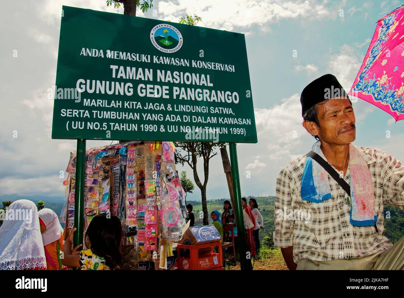 Villagers are photographed with the sign of Gede Pangrango National Park in Nagrak, a farming village located on the border of Gede Pangrango National Park in Cibadak, Sukabumi, West Java, Indonesia. Stock Photo