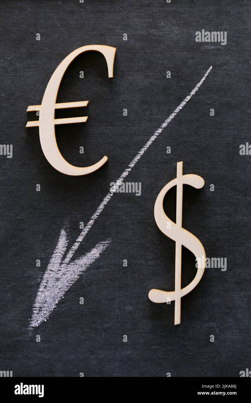 Falling currency rate. Euro and Dollar sign and a white down arrow on a black background.Dollar and Euro inflation. Financial Crisis.Exchange rate and Stock Photo
