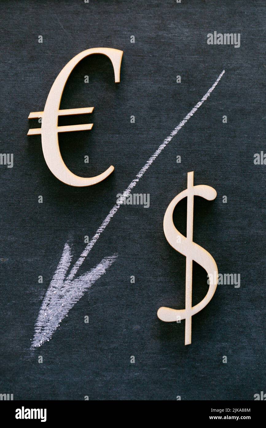 Euro and Dollar sign and a white down arrow on a black background. Financial Crisis.Exchange rate and Euro dollar Price increase.European economic  Stock Photo