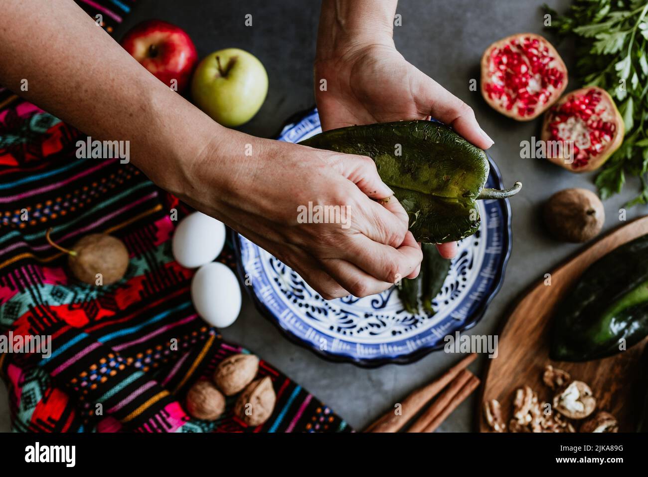 mexican woman hands peeling poblano chillies pepper for cooking chiles ...