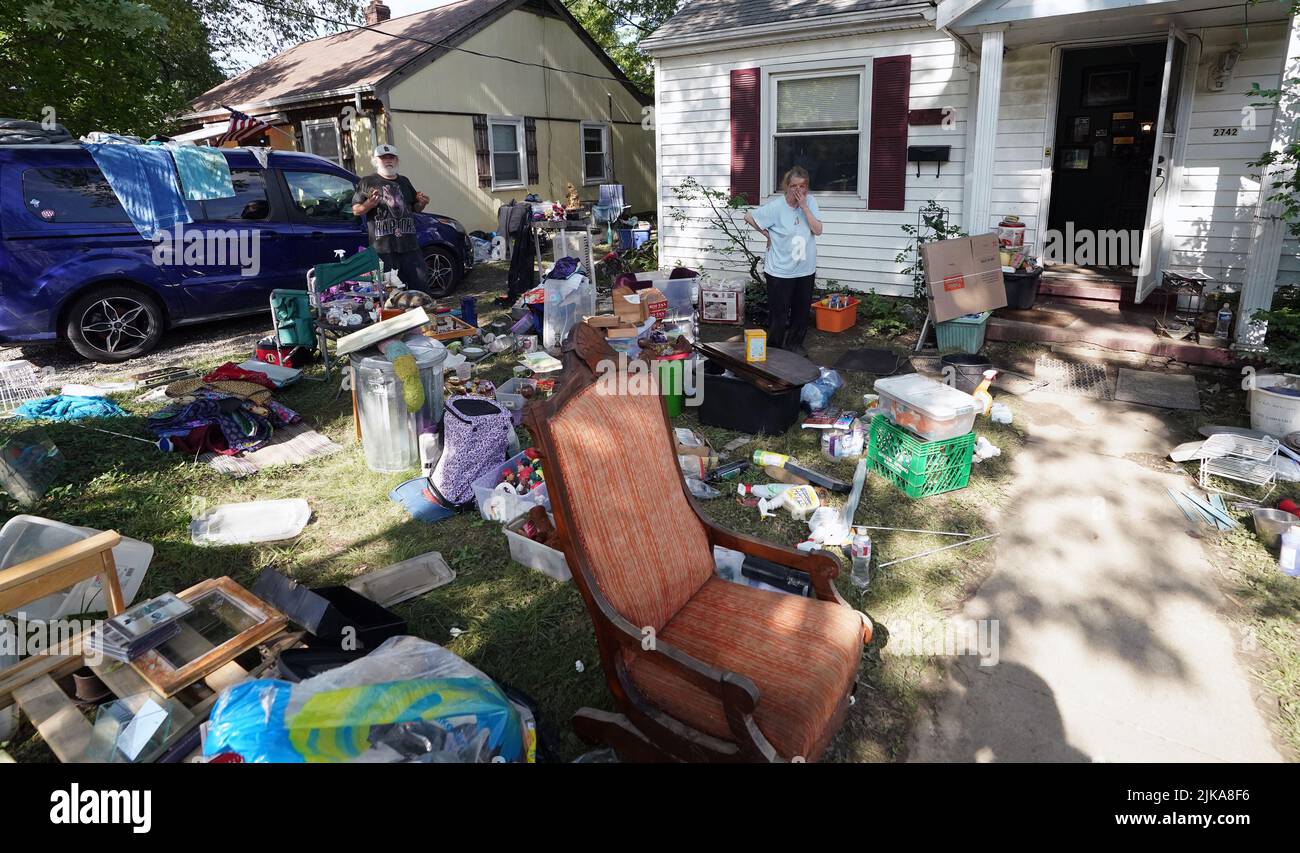 St. Louis, United States. 31st July, 2022. Resident Lynn Hartke looks over her possessions placed in her front yard to dry out after historic flooding in St. Louis on Sunday, July 31, 2022. Heavy rains on July 26 and 28 displaced over 1100 households in St. Louis. Photo by Bill Greenblatt/UPI Credit: UPI/Alamy Live News Stock Photo