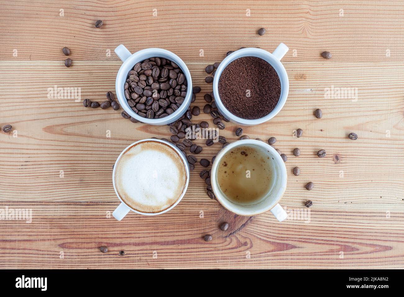 Four cups of coffee. One with coffee beans, one with ground coffee