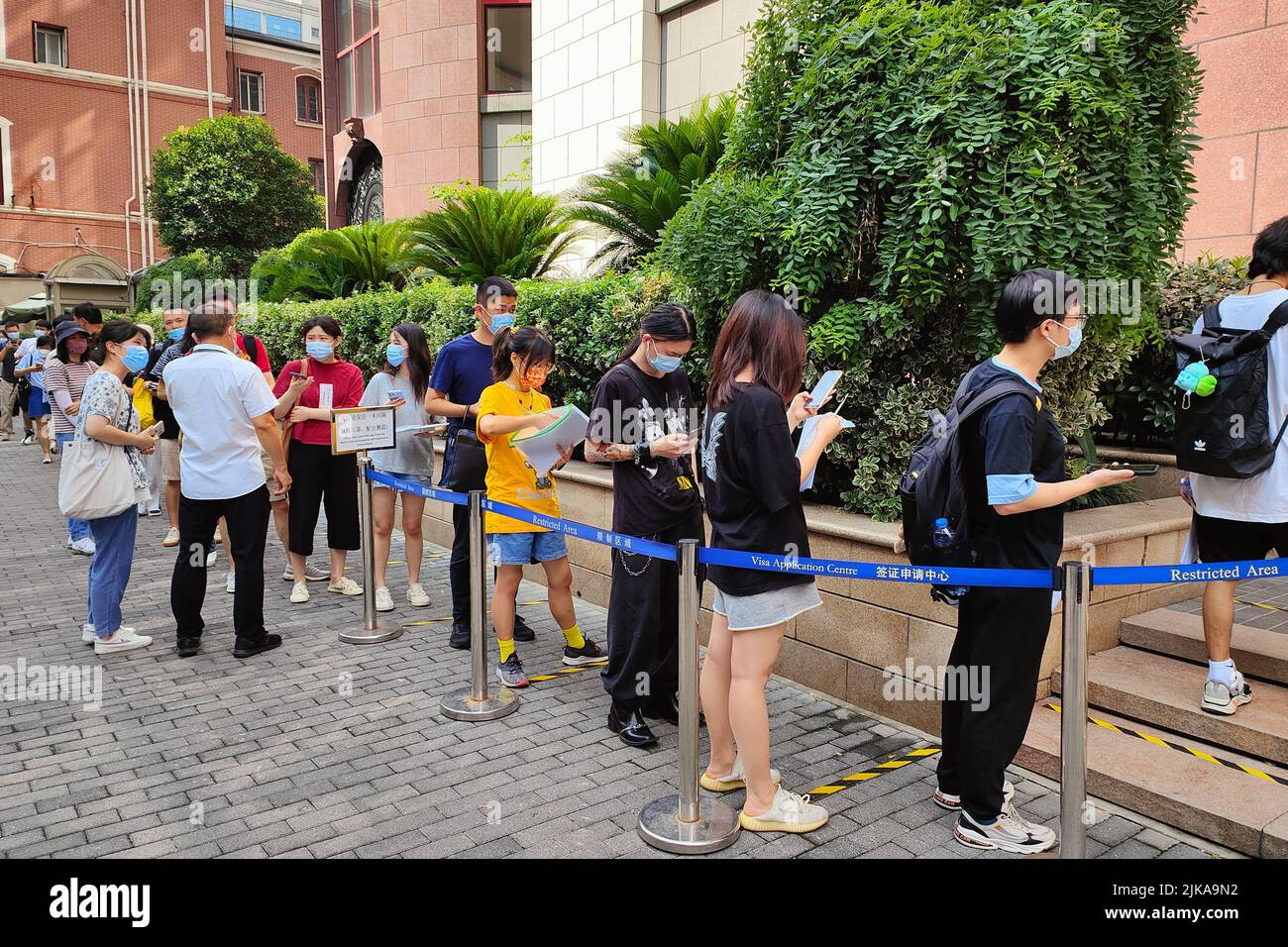 SHANGHAI, CHINA - AUGUST 1, 2022 - A long queue forms in front of a visa  center in Shanghai, China, on Aug 1, 2022. 213 Sichuan Middle Road is home  to visa