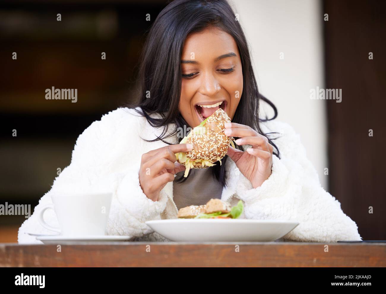 Lunchtime is the best part of my day. a young woman eating. Stock Photo
