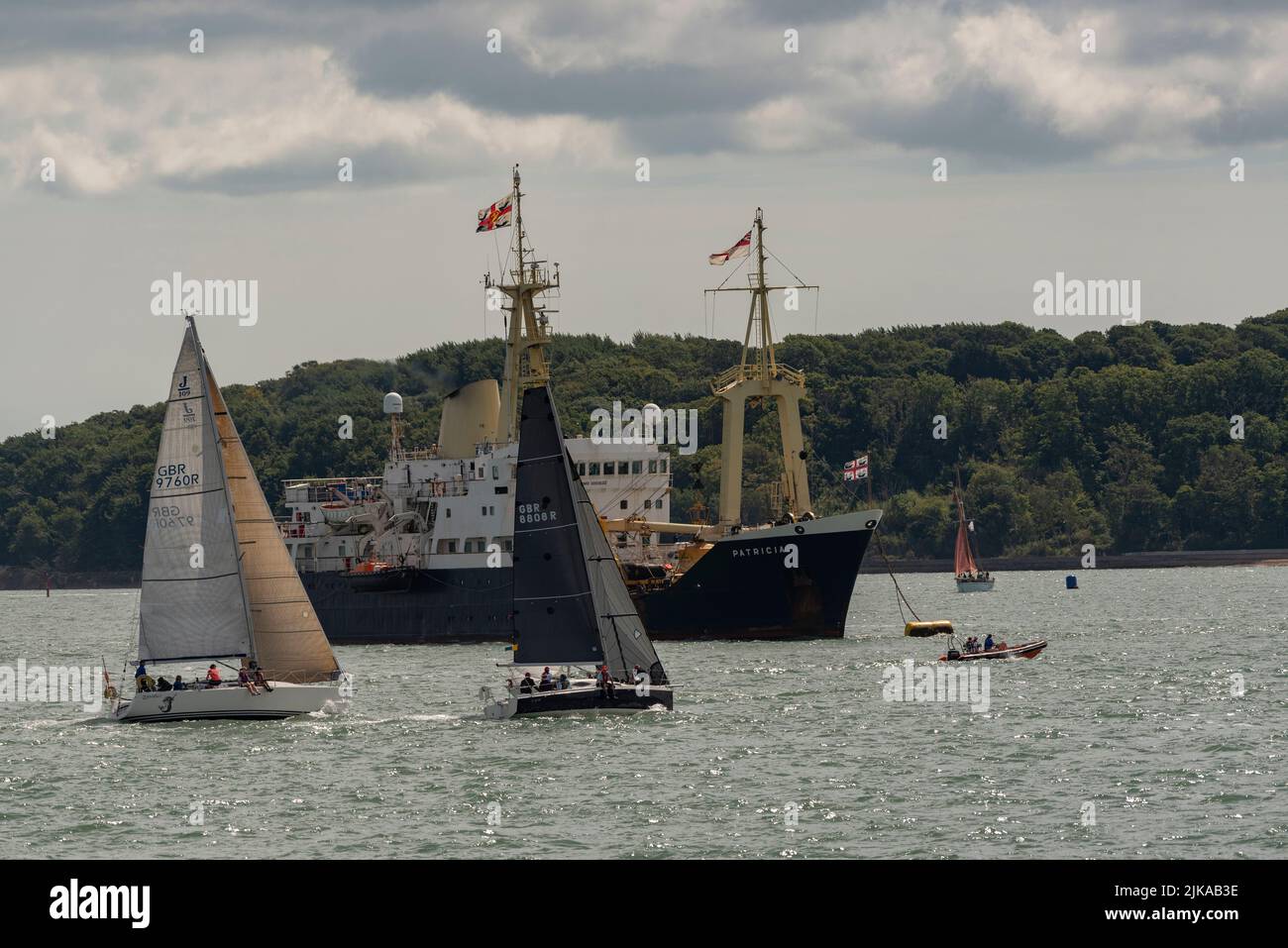 Cowes, Isle of Wight, England, UK.2022. Racing yachts sail past the