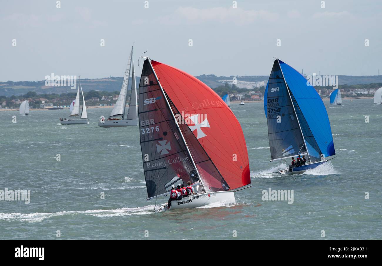The Solent, southern England, UK. 2022. Foreground the Radley College crew aboard Trouble and Strife competing in the Cowes Week regatta. Stock Photo