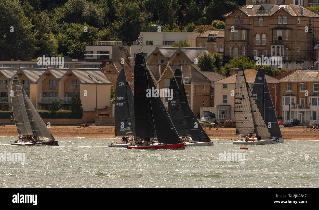 Cowes, Isle of Wight, England, UK. 2022. Racing yachts close to the shore during Cowes Week regatta in Cowes, UK. Stock Photo