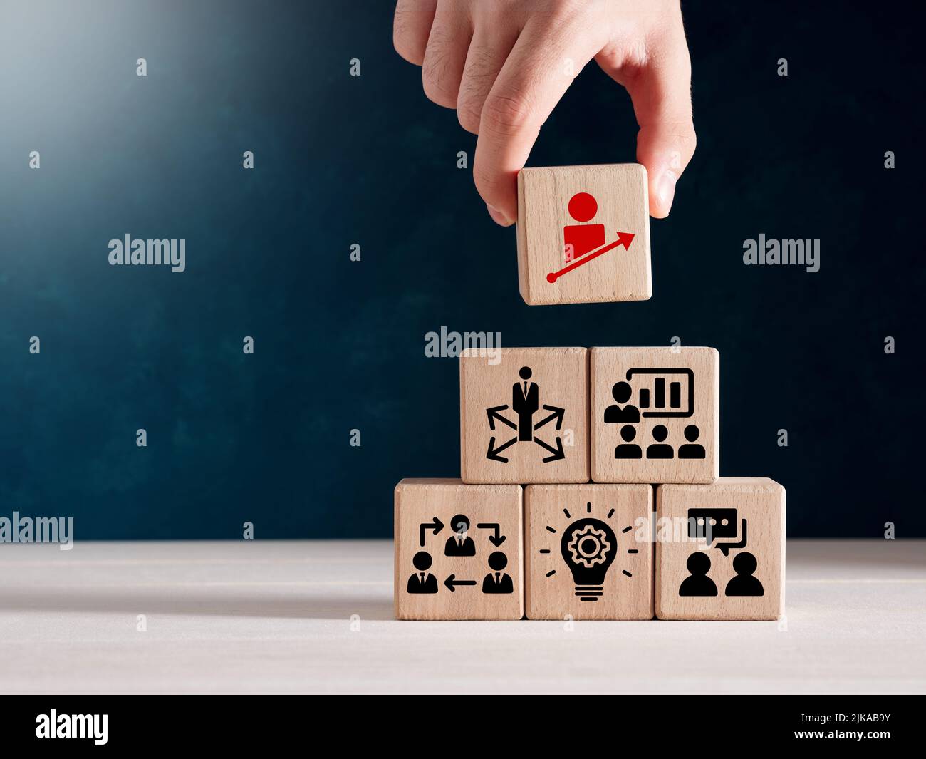 Business personal development, improving and developing competency and business performance. Hand holds wooden cubes with personal growth icon on stac Stock Photo