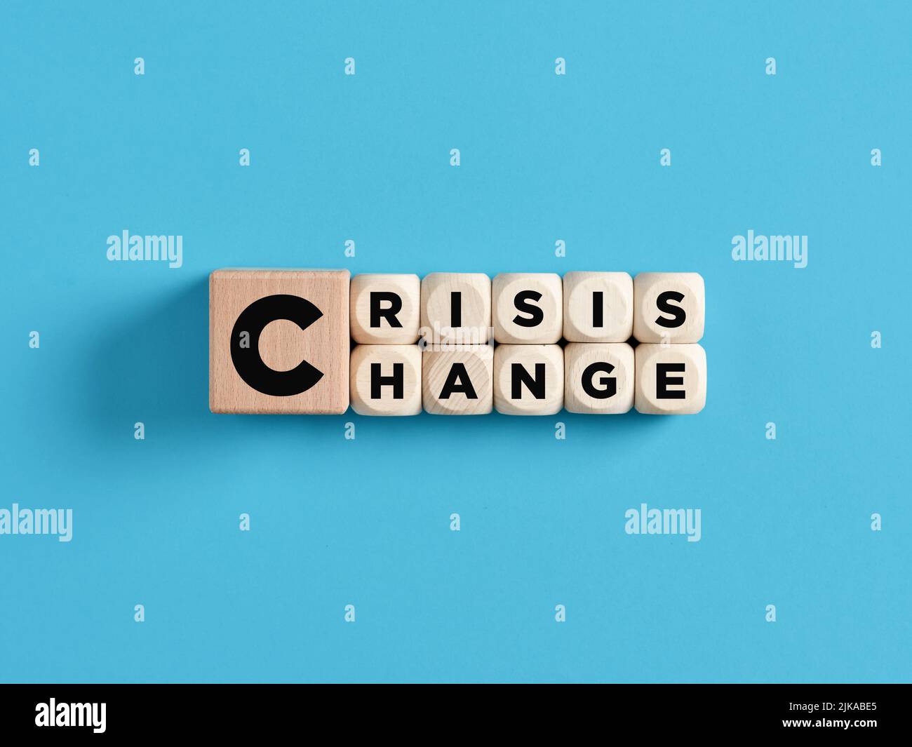 Transforming crisis into a chance for a change concept. The words crisis and change on wooden cubes. Stock Photo
