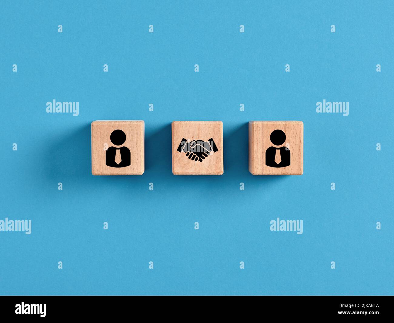 Business deal, agreement or contract concept. Employee manager and handshake icons on wooden cubes Stock Photo