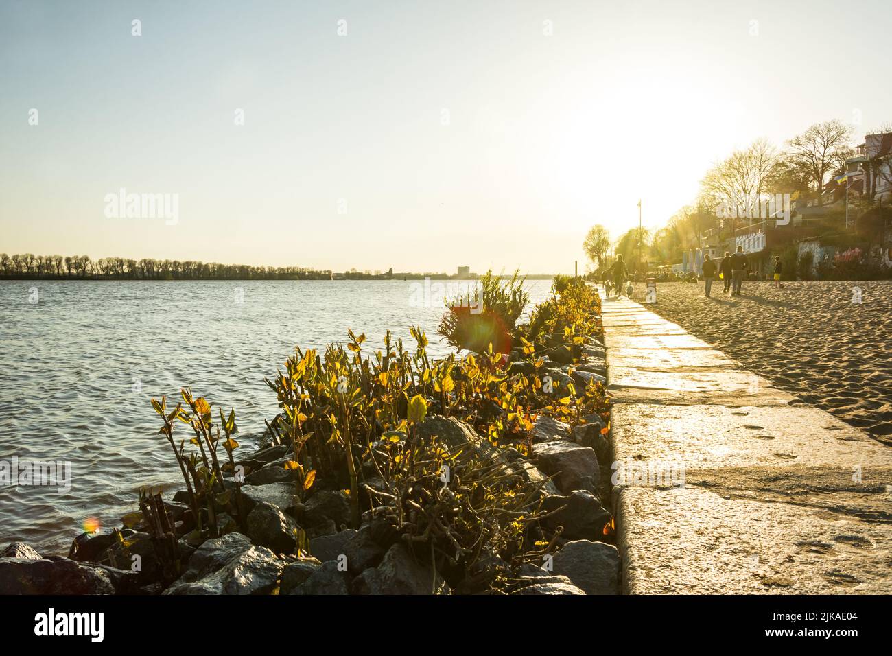 Scenic golden sunset at the famous city beach (Elbstrand) of the Elbe River in Hamburg, Germany Stock Photo