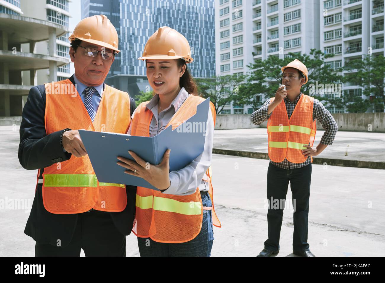 Investor and engineer discussing document at the site Stock Photo