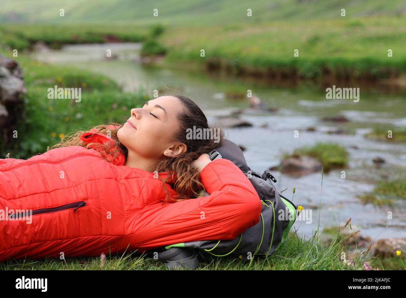 Hiker resting lying in a riverside Stock Photo