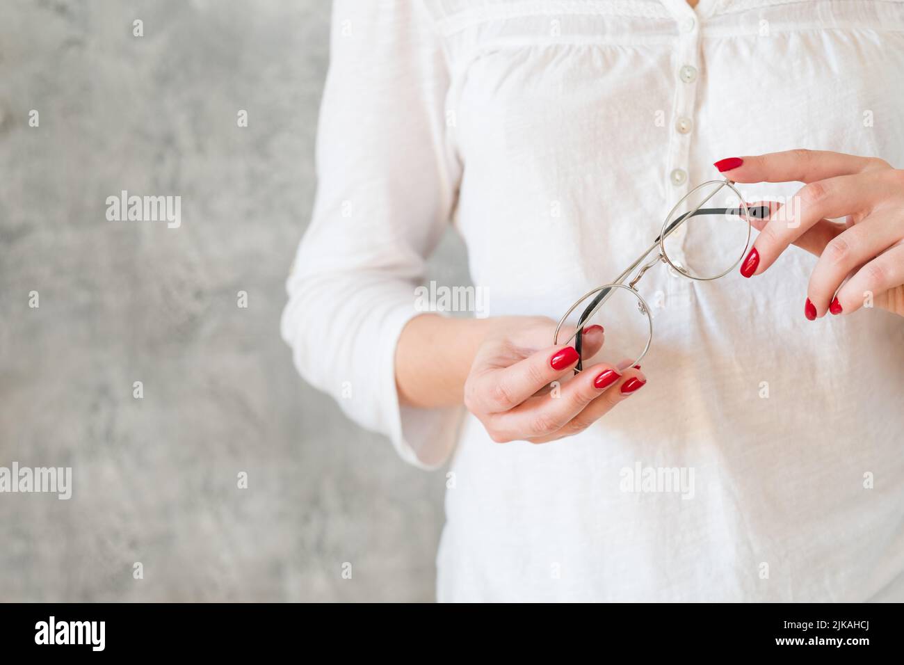 woman hold eyeglasses eyewear reading hobby Stock Photo Alamy