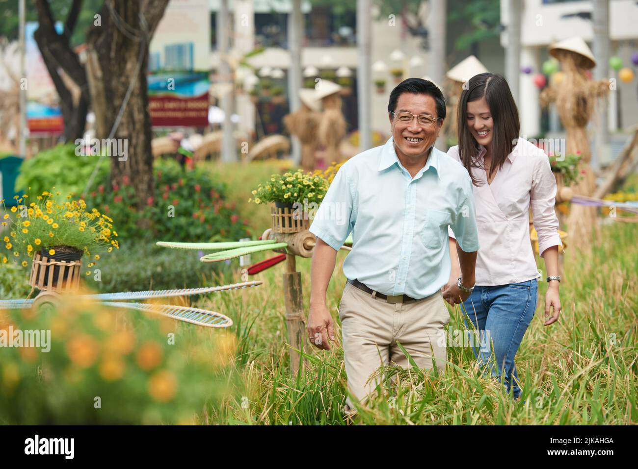 Happy Asian father and daughter walking in the park Stock Photo - Alamy