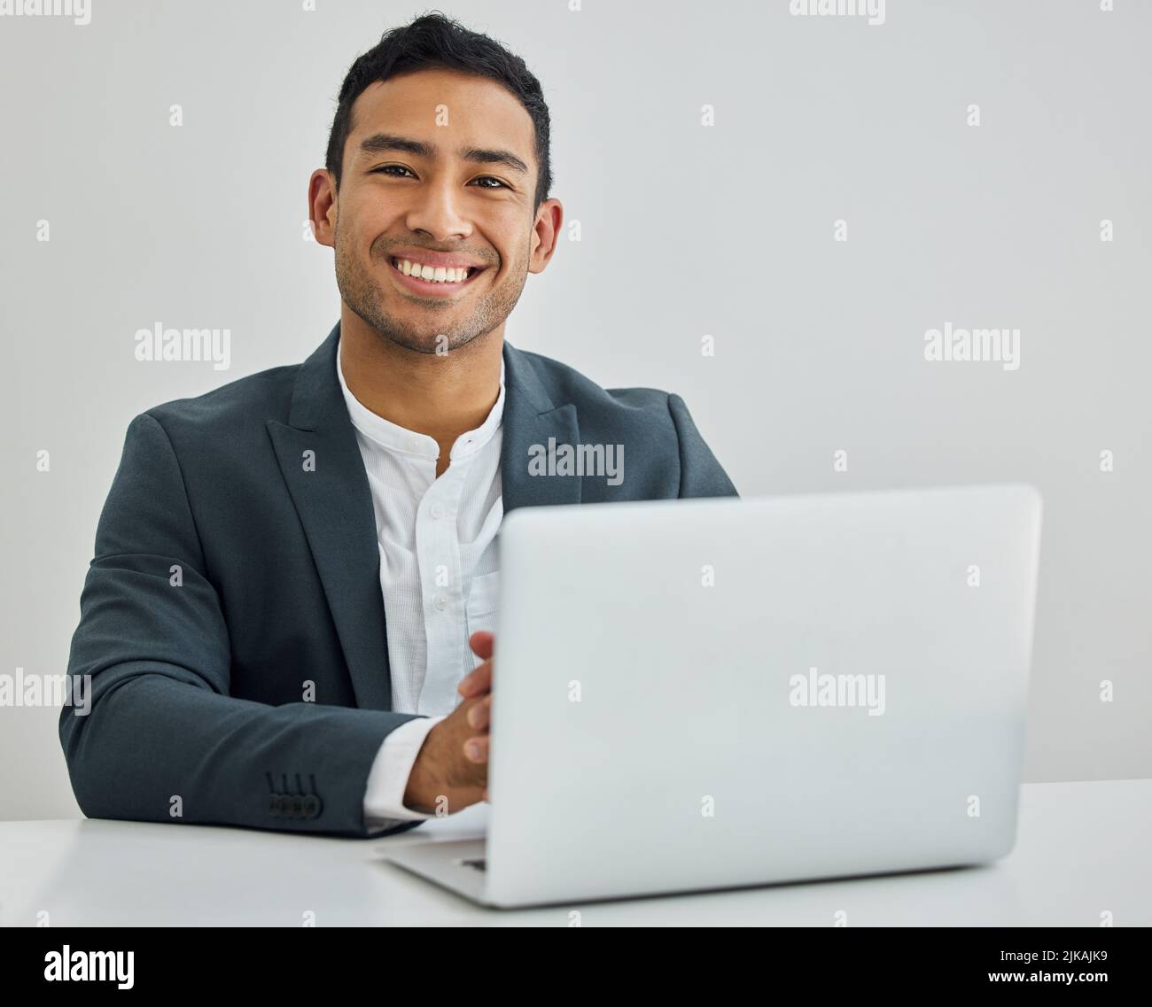 Remember me- the man you thought id never be. Portrait of a businessman using a laptop at his desk in a modern office. Stock Photo