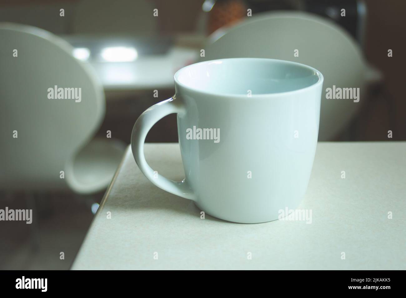 White empty mug standing on the counter Stock Photo